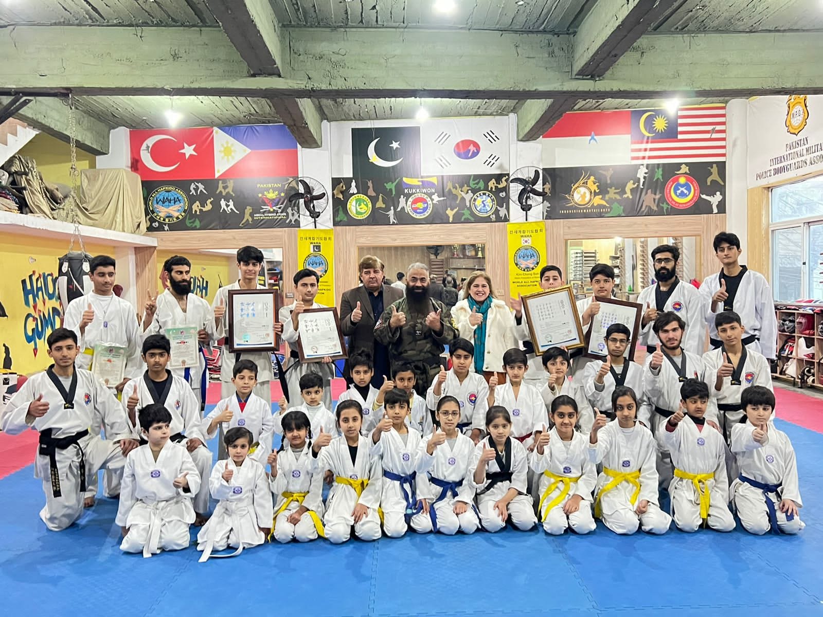 a group of people posing for a photo martial arts in pakistan